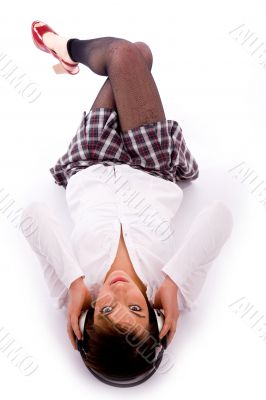 high angle view of woman on floor listening music
