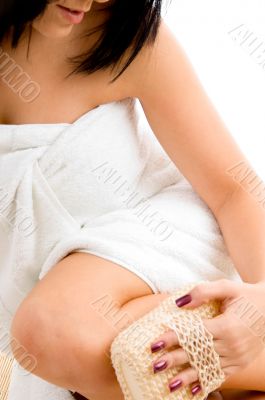 woman scrubbing her leg with white background
