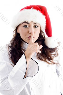 chef wearing christmas hat and shush with finger
