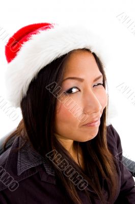young female in christmas hat winking