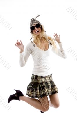 side view of woman in cap jumping high
