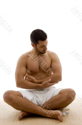 front view of man sitting with his legs crossed
