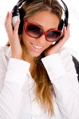 portrait of smiling female listening music