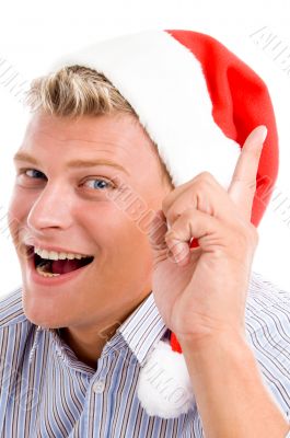 man pointing up with christmas hat