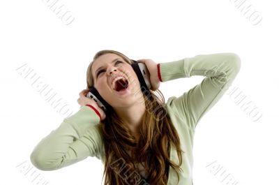beautiful female rocking on listening music