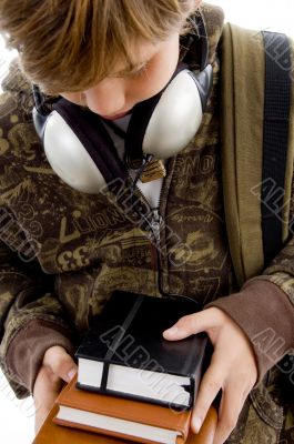 front view of boy with books and headphone