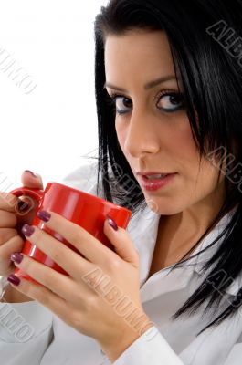 female doctor holding mug on white background