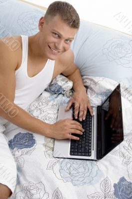 smiling man working on laptop