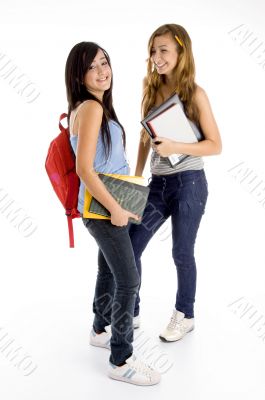 standing students posing with bag and books
