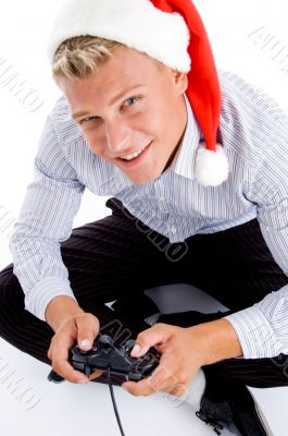 man with christmas hat and playing video games