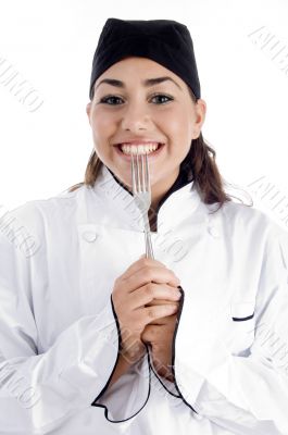 smiling female chef showing fork
