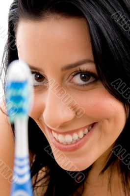 smiling woman with toothbrush on white background