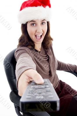 woman in christmas hat holding remote control