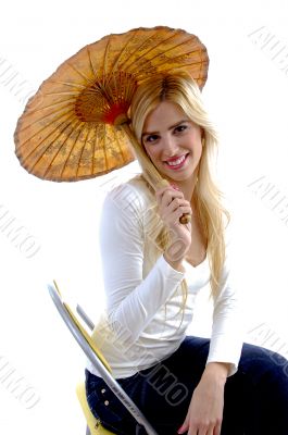 side view of happy young woman holding umbrella