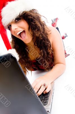 woman wearing christmas hat and working on laptop