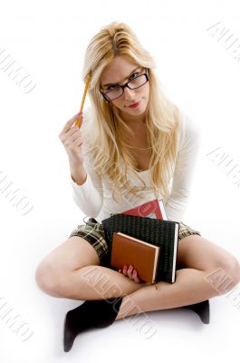 front view of smiling young student holding books
