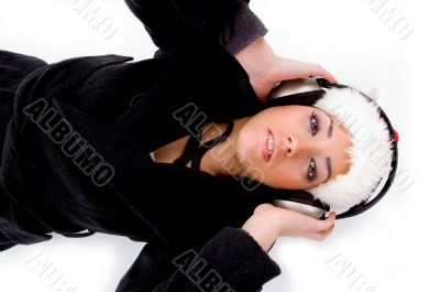 lying female listening music on headphone