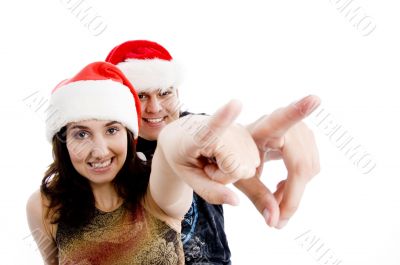 portrait of pointing couple with christmas hat