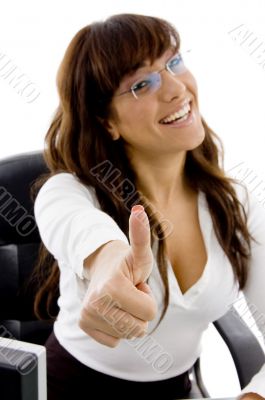 smiling female executive with thumbs up