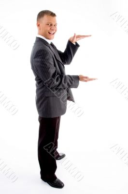 side pose of standing measuring businessman