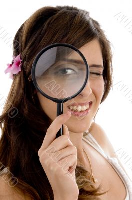 female looking through magnifying glass