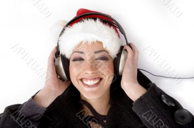 female listening music and wearing christmas hat