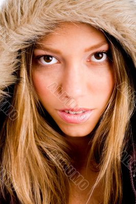 young woman with winter coat looking at camera