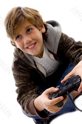 side view of amused boy playing videogame
