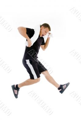 man with towel around his neck and jumping high