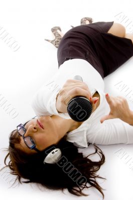 businesswoman lying down holding a microphone