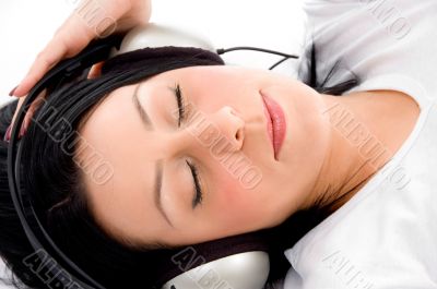 laying female enjoying music