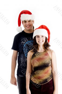 standing young couple wearing christmas hat