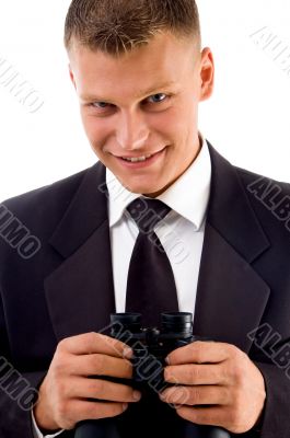 young executive holding binoculars smiling