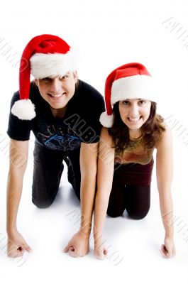 couple with christmas hat and looking at camera