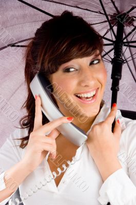 woman talking on phone and holding an umbrella