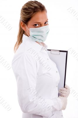 medical professional with writing pad and mask