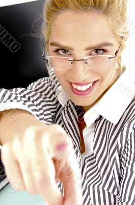 front view of smiling woman pointing
