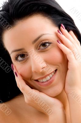 smiling woman touching her face