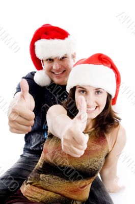 people with christmas hat showing thumbs up
