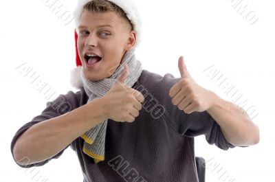 smiling man with christmas hat showing thumbs up