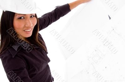 young female engineer searching opened blue prints