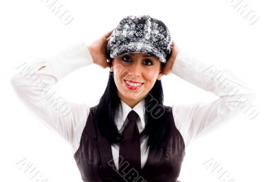 young woman in cap posing with her arms