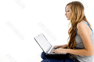 blonde female student working on laptop