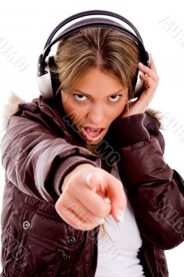 front view of pointing woman enjoying music