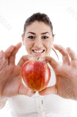 young attractive woman holding a fresh red apple