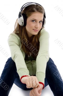 sitting female listening track on headphone
