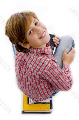 top view of boy with pile of books