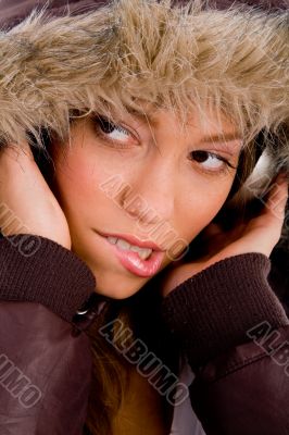 adult woman with woolen coat listening music