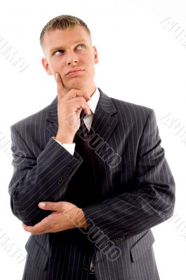 thinking young businessman looking upward