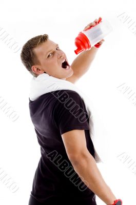 muscular man drinking from water bottle